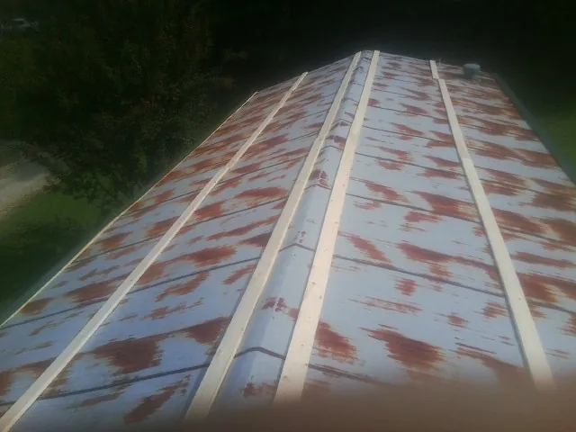 Rusted metal roof panels with new wood purlins before replacement — Storm Damage Roof Repair in Owasso by Roofing Brothers